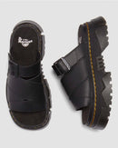 Black Dr. Martens sandals on a light gray background