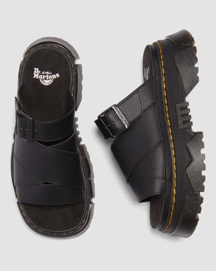 Black Dr. Martens sandals on a light gray background