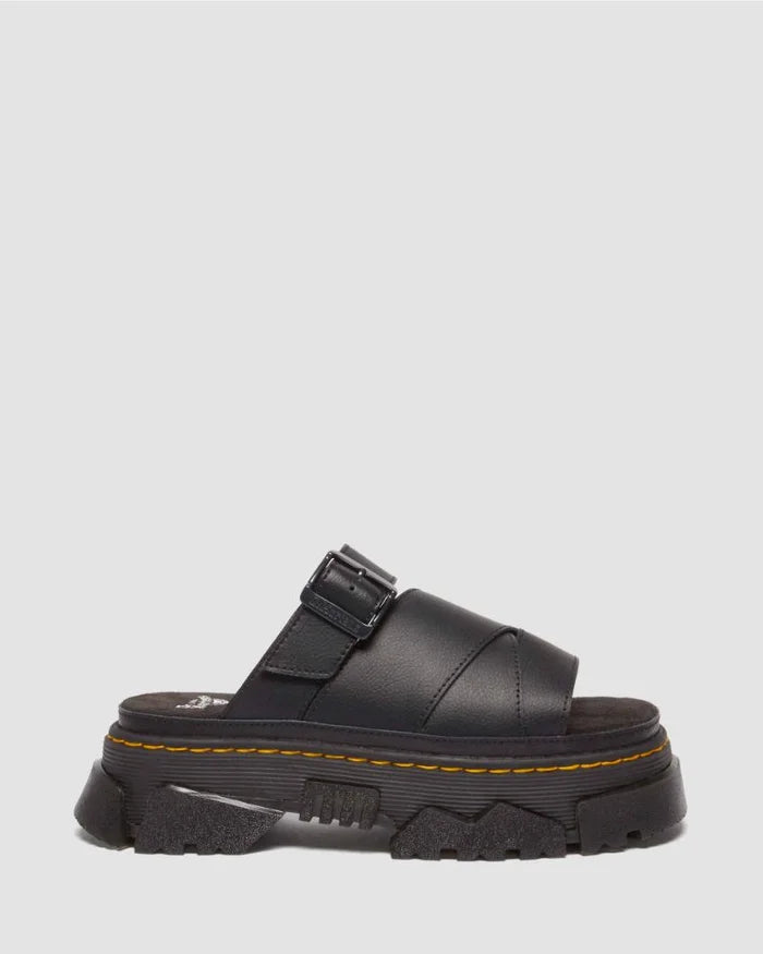 Black sandal with a thick sole on a light gray background