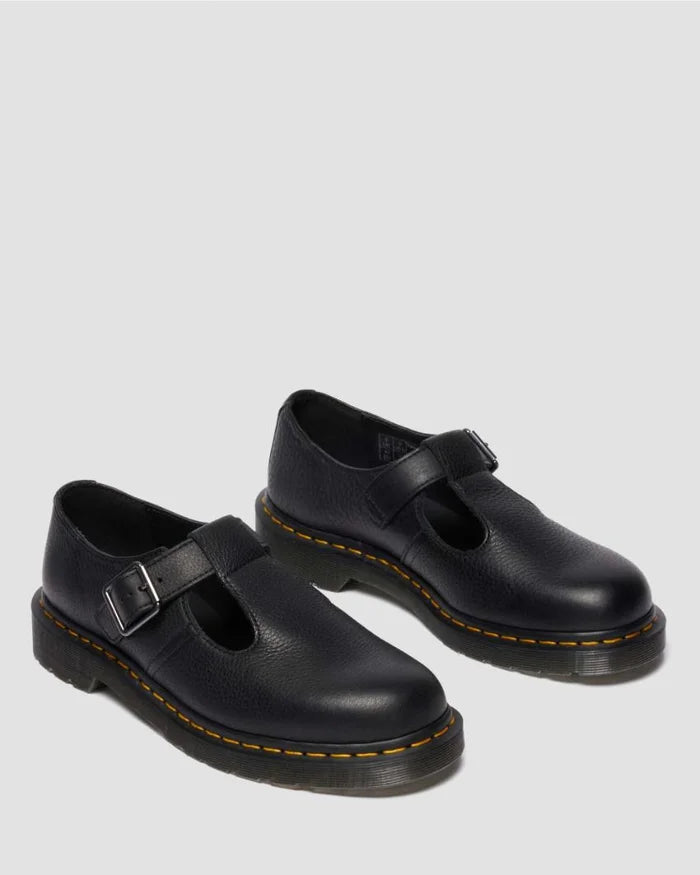 Pair of black shoes with buckles on a light gray background