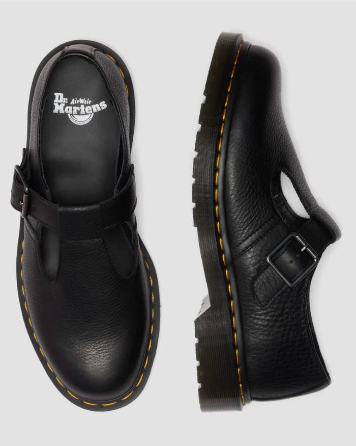 Black leather shoes with buckles on a light gray background