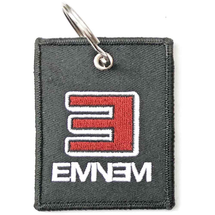 Gray keychain with red and white logo on a white background