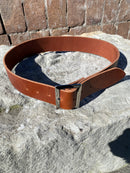 Brown leather belt on a stone surface