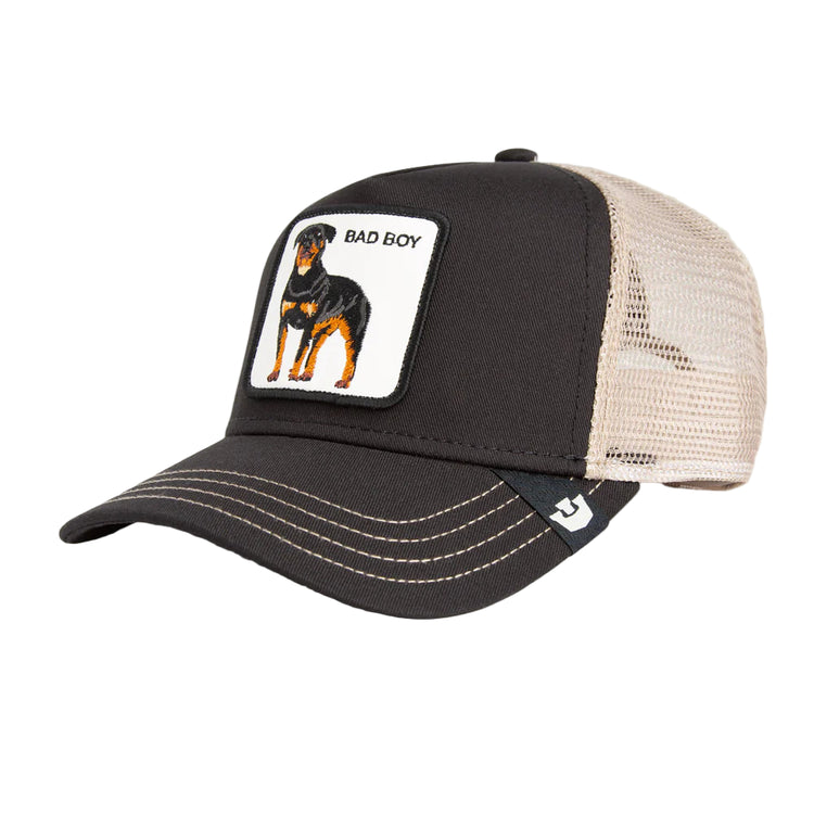 Black and beige cap with a dog patch labeled 'Bad Boy' on a light gray background