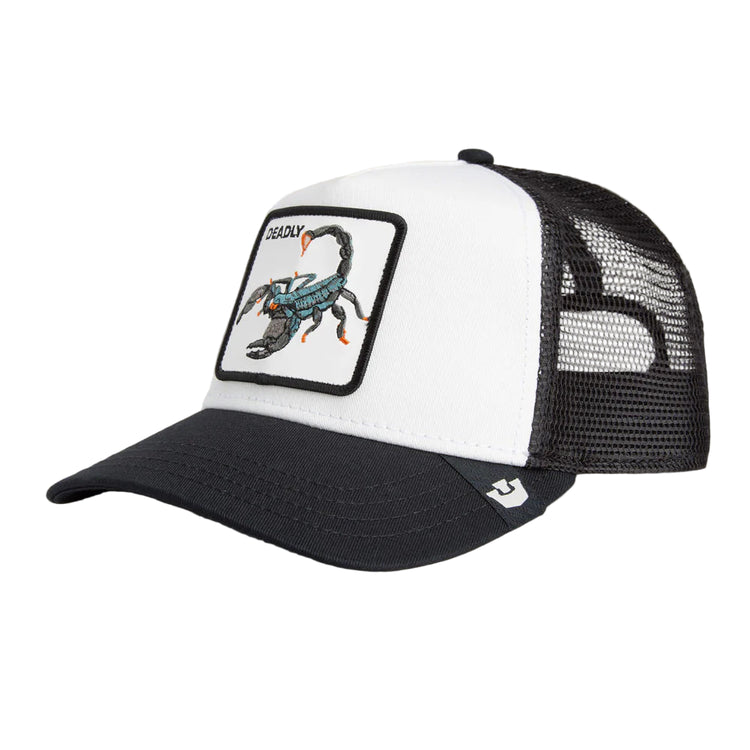 Black and white cap with a scorpion patch on a beige background