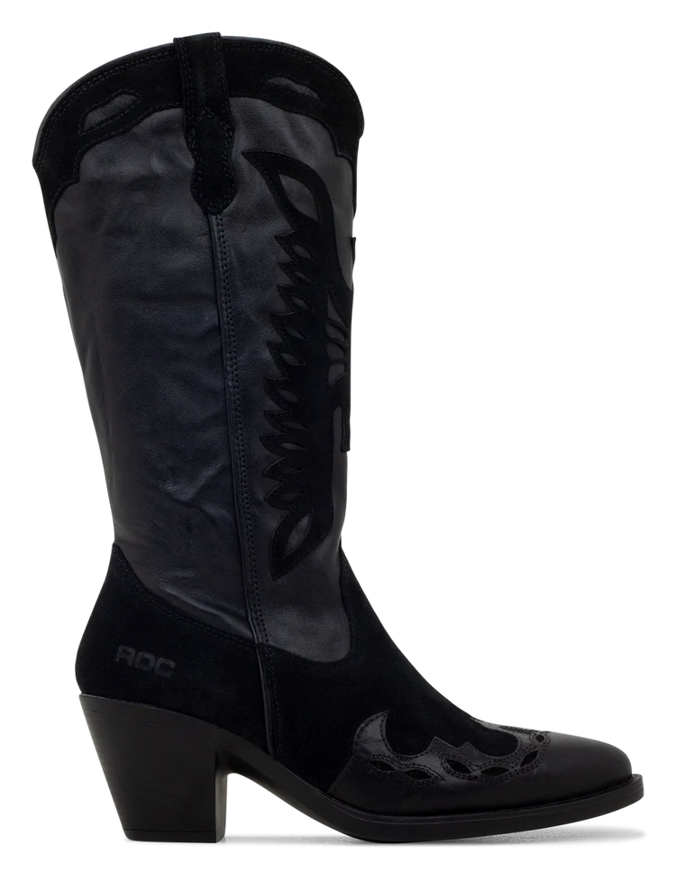 A black suede boot with a pointed toe, decorative suede leather overlays, and a low heel.