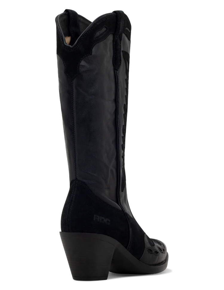 A black suede boot with a pointed toe, decorative suede leather overlays, and a low heel.