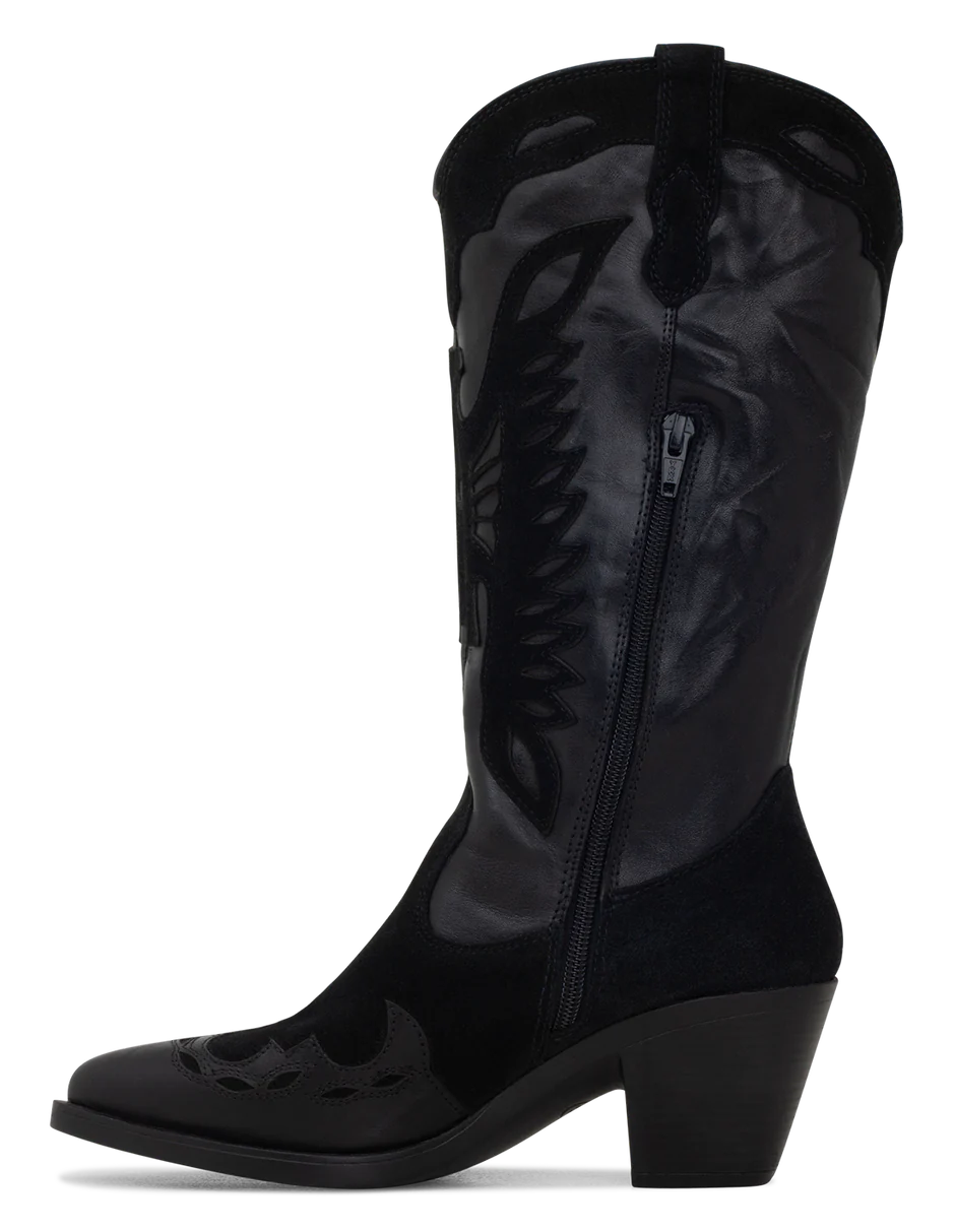 A black suede boot with a pointed toe, decorative suede leather overlays, and a low heel.