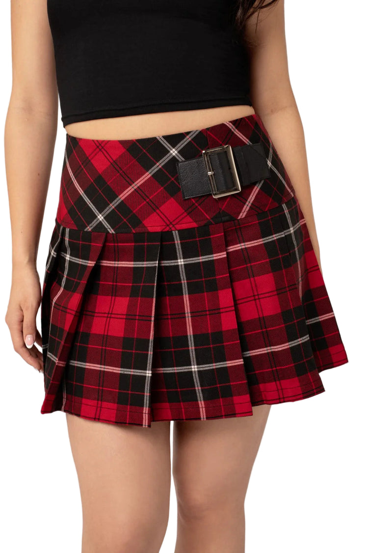 Red and black plaid skirt with a belt on a plain background