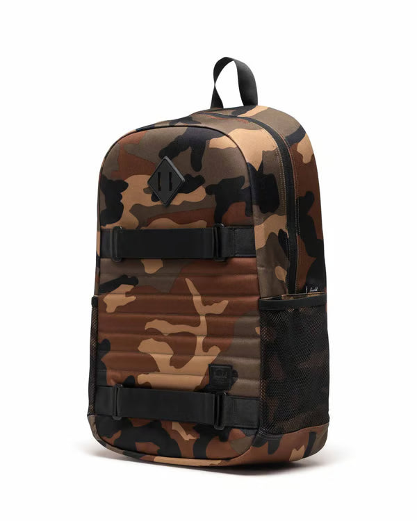 Camouflage backpack with black accents on a white background