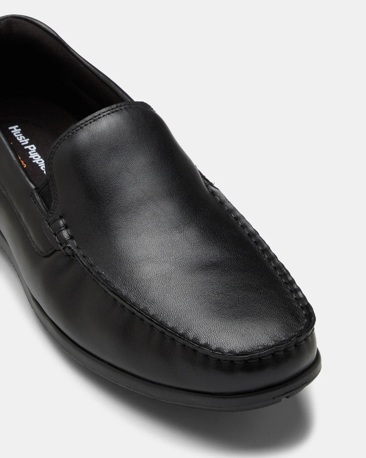 Black leather loafer shoe on a white background