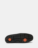 Black shoe sole with orange accents on a white background