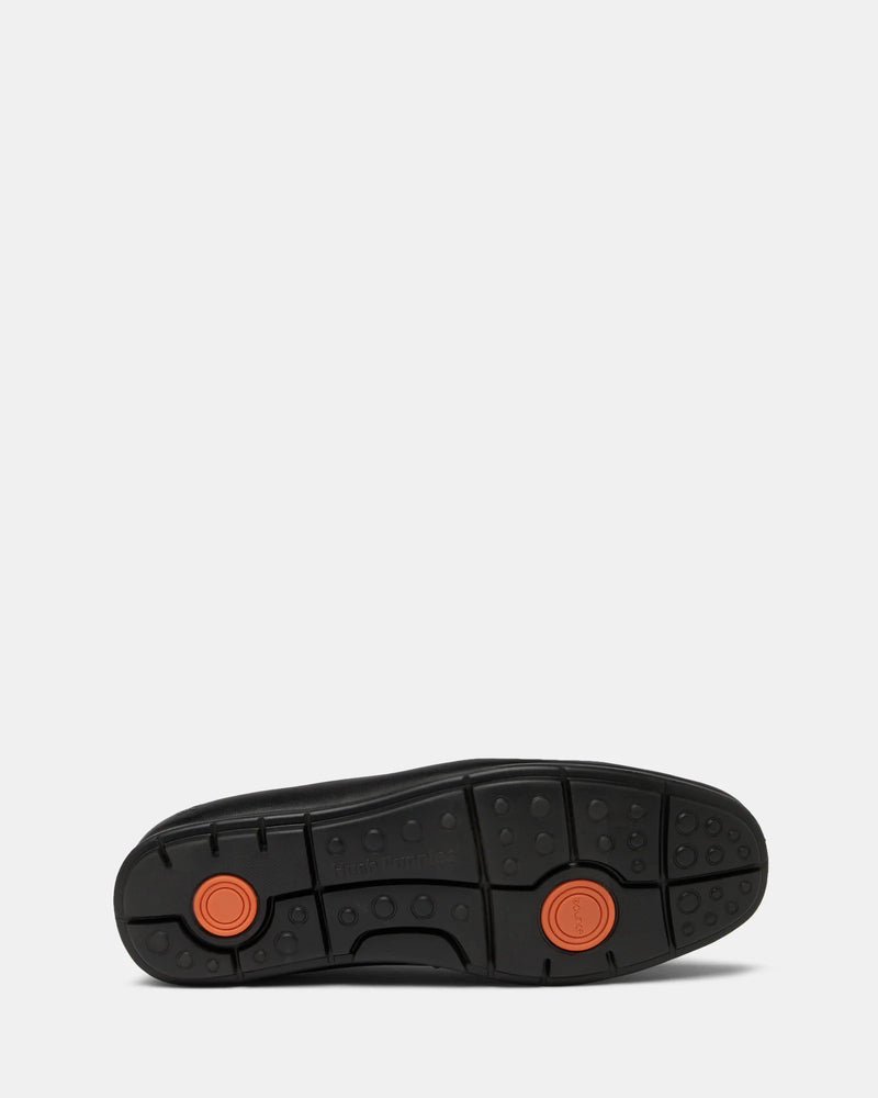Black shoe sole with orange accents on a white background
