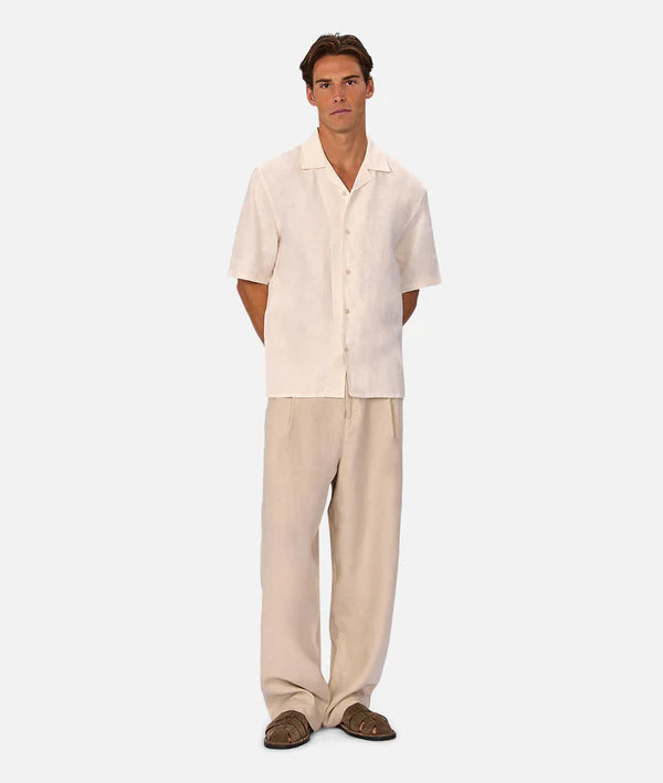 Man wearing a beige shirt and pants set on a white background
