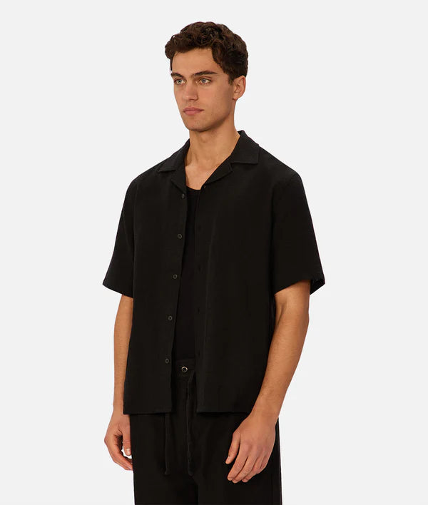 Man wearing a black short-sleeve shirt on a white background