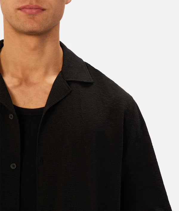 Close-up of a person wearing a black shirt on a white background