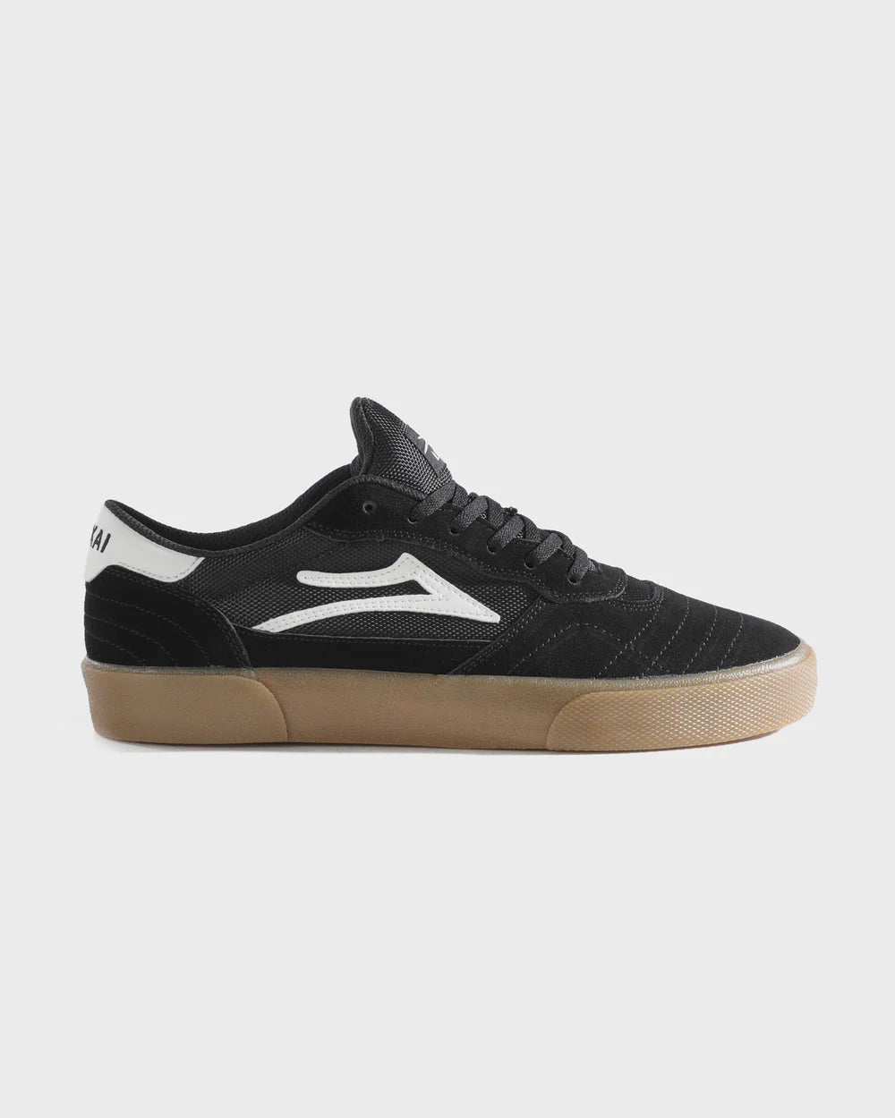 Black sneaker with white logo on a light gray background