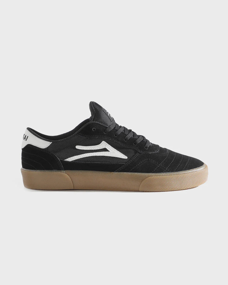 Black sneaker with white logo on a light gray background