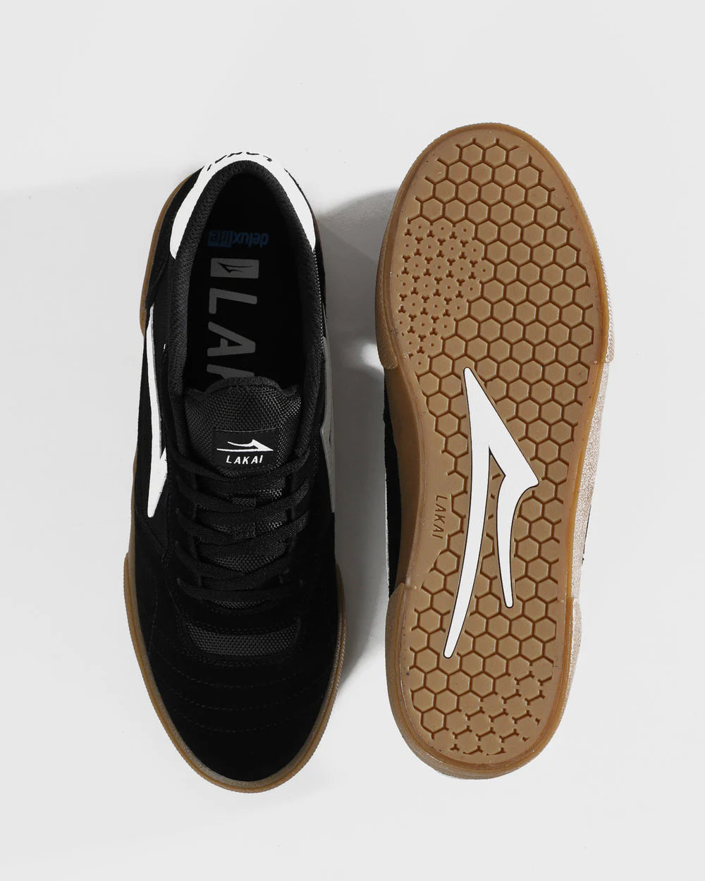 Black sneaker with white accents on a light gray background