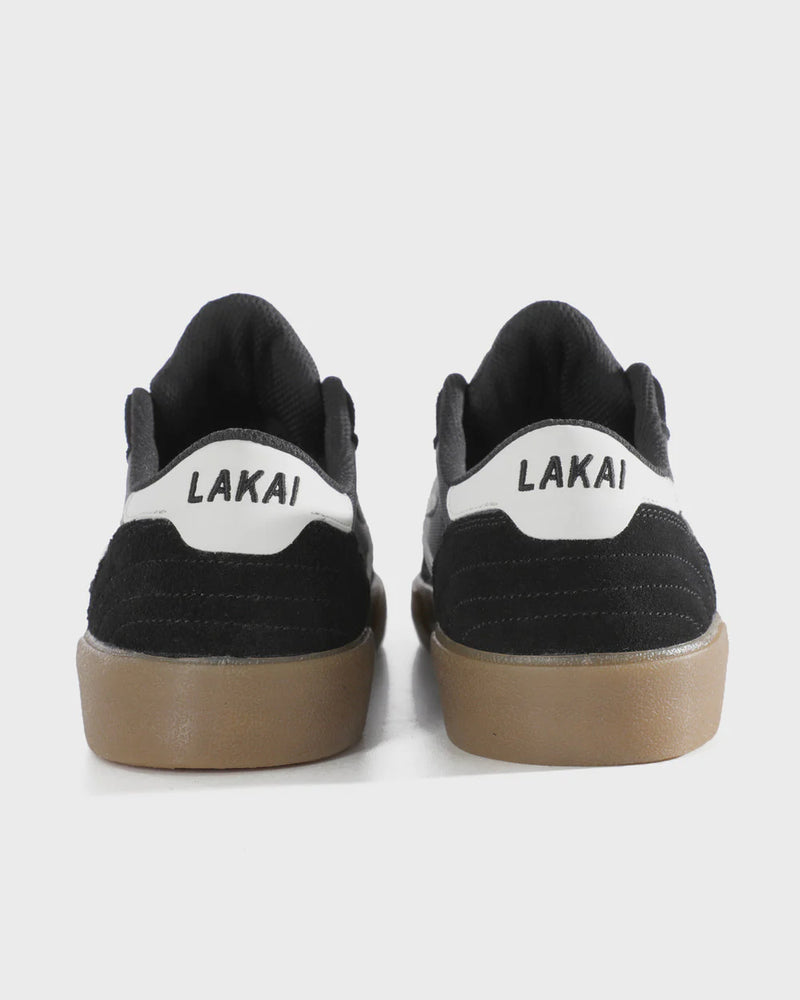 Black sneakers with 'Lakai' branding on a white background
