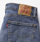 Close-up of Levi's jeans with brand label and pocket detail on a white background