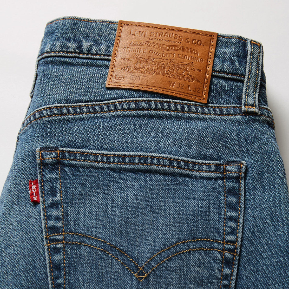 Close-up of Levi's jeans with brand label on a light gray background