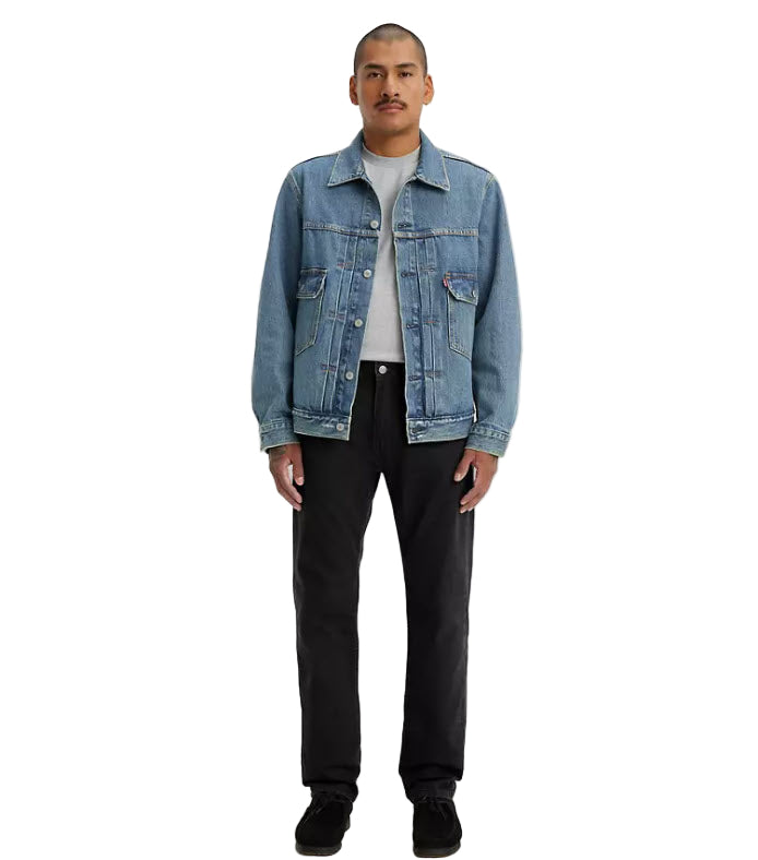 Person wearing a blue denim jacket on a white background