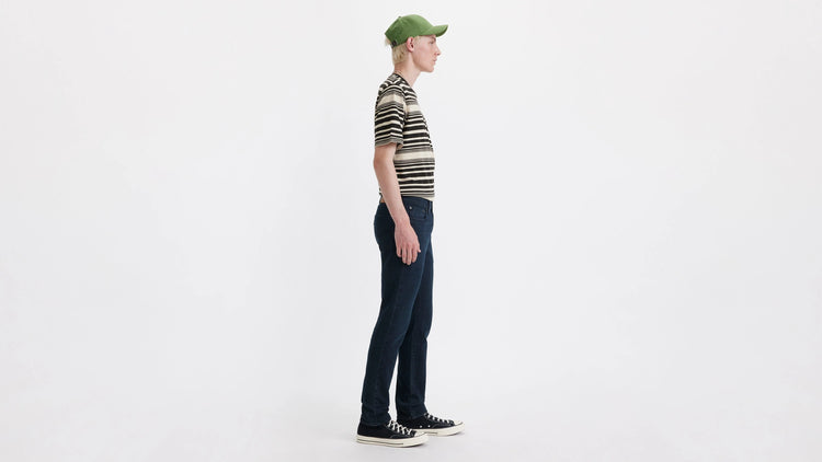 Person wearing a striped shirt and green cap on a white background