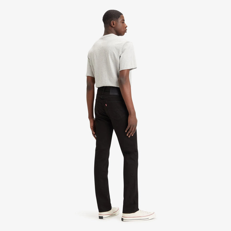 Person wearing a white shirt and black pants on a white background