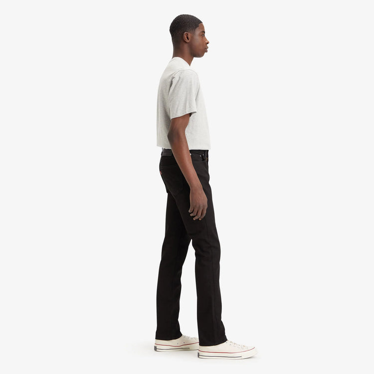 Person wearing a white shirt and black pants on a white background
