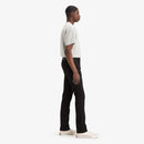 Person wearing a white shirt and black pants on a white background