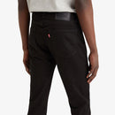 Person wearing black pants with a visible brand logo on a white background