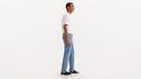 Person wearing blue jeans and a white shirt on a white background
