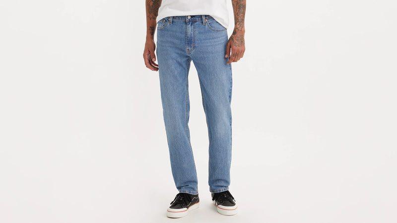 Person wearing light blue jeans on a white background