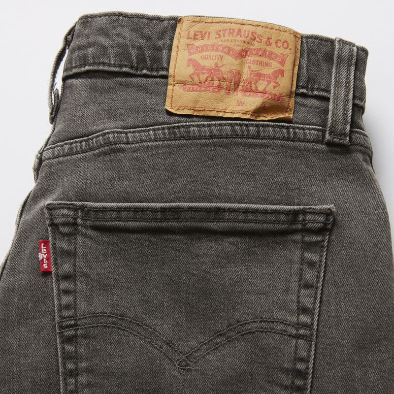 Gray Levi's jeans with a visible brand label on a light gray background