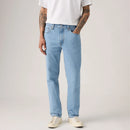 Person wearing light blue jeans and a white t-shirt on a plain background
