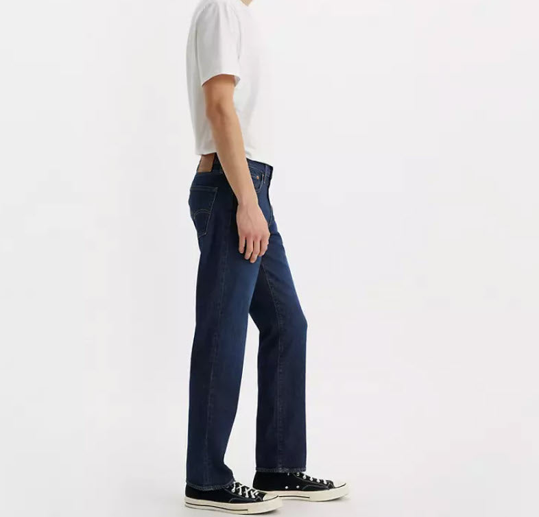 Person wearing dark blue jeans and a white shirt on a white background