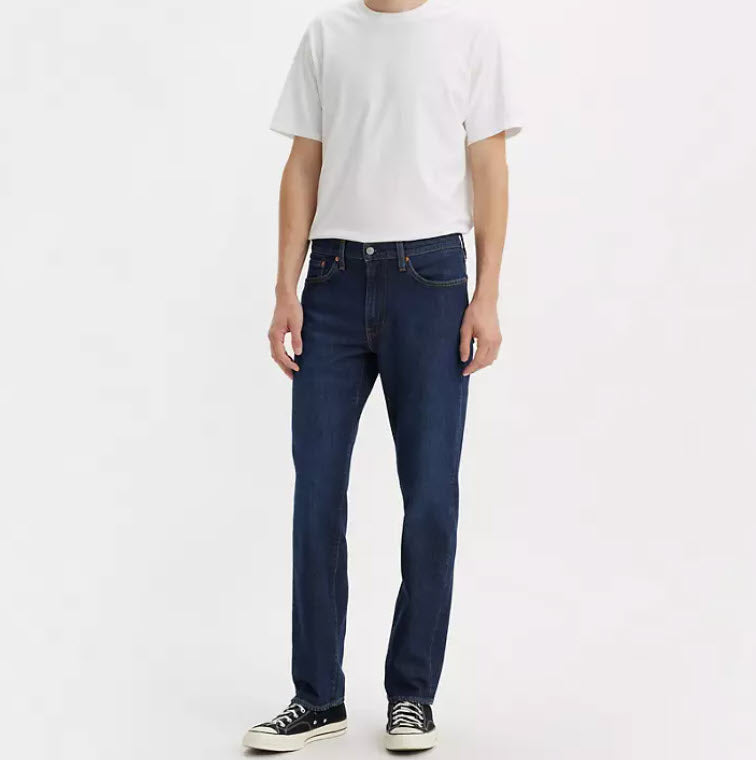 Person wearing dark blue jeans and a white t-shirt on a white background