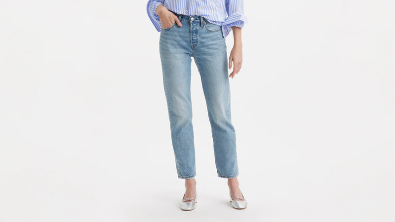 Light blue jeans worn by a person on a white background