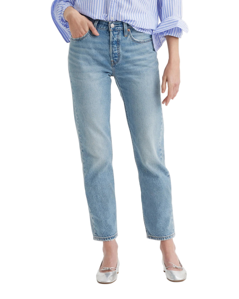 Light blue Levi's jeans worn by a person on a white background