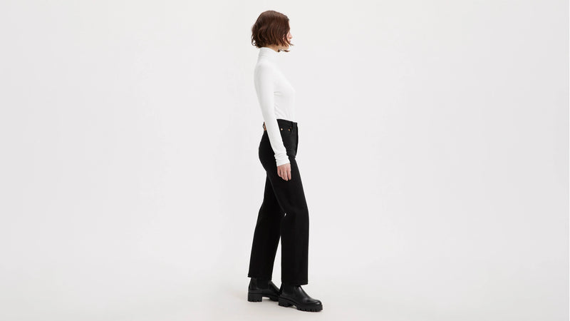 Person wearing a white shirt and black pants on a white background