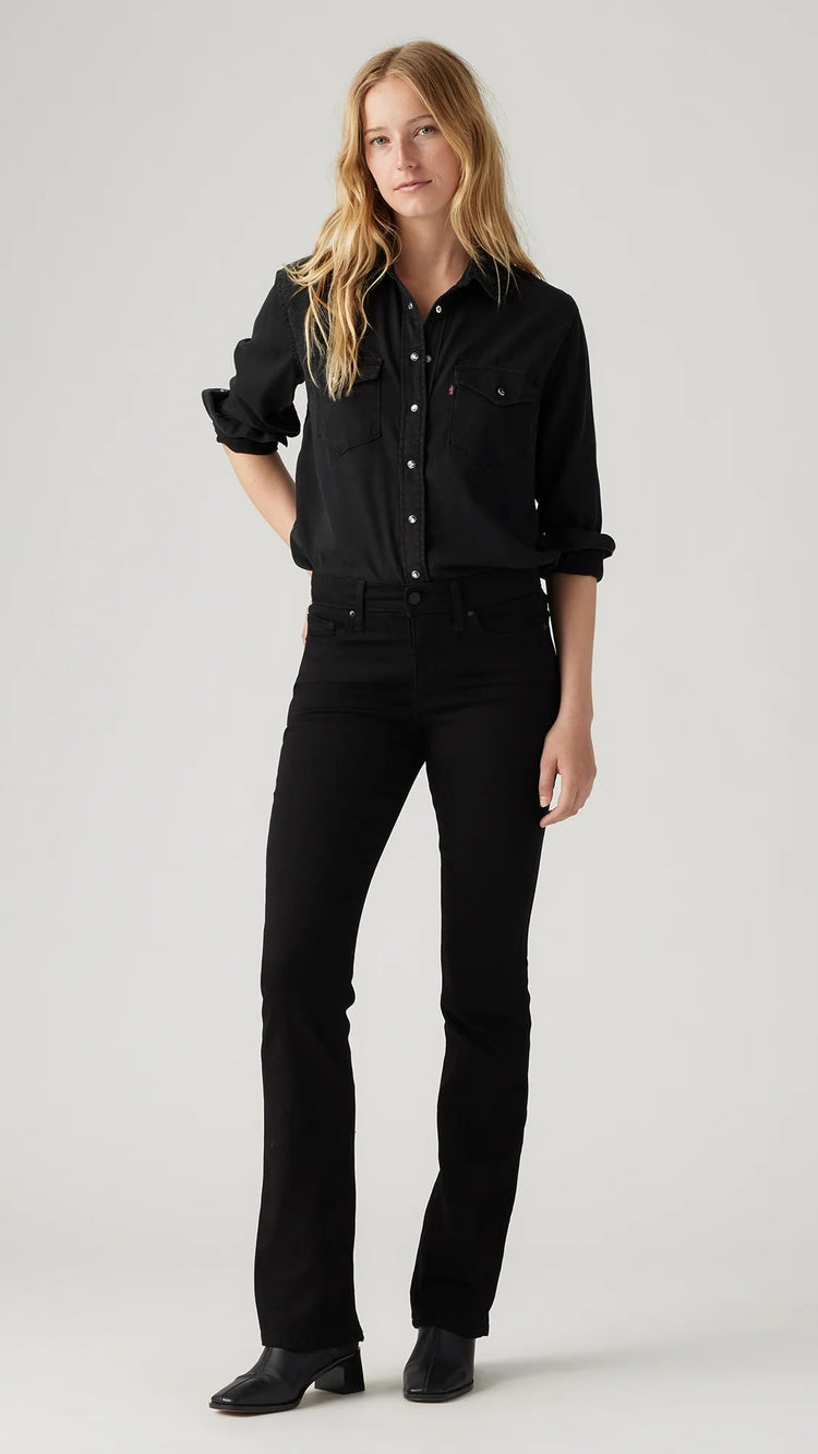Person wearing a black outfit on a plain background