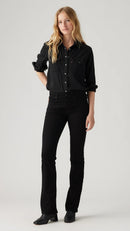 Person wearing a black outfit on a plain background