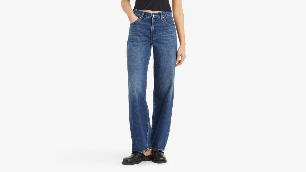Person wearing blue jeans on a white background