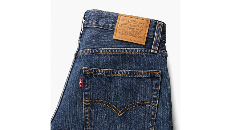 Blue denim jeans with a Levi's label on a white background