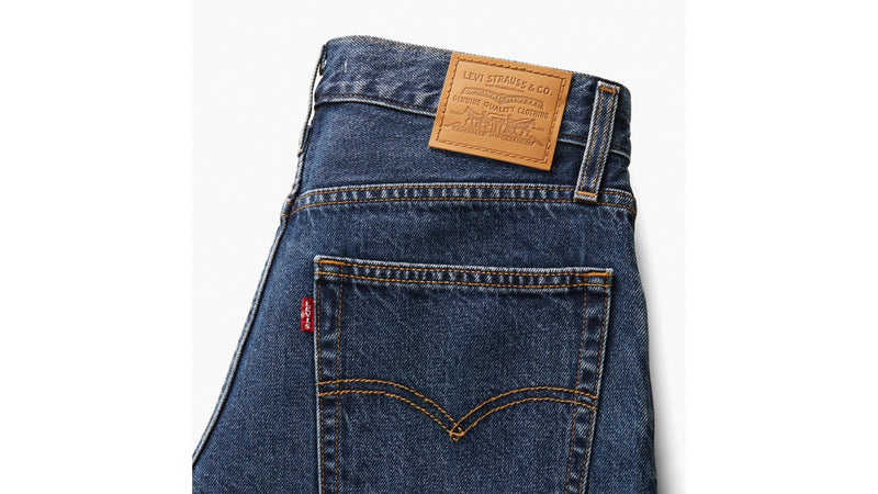 Blue denim jeans with a Levi's label on a white background
