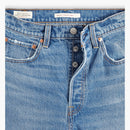 Close-up of blue jeans with Levi's branding on a white background