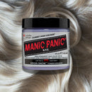Manic Panic hair color cream jar on a background of blonde hair