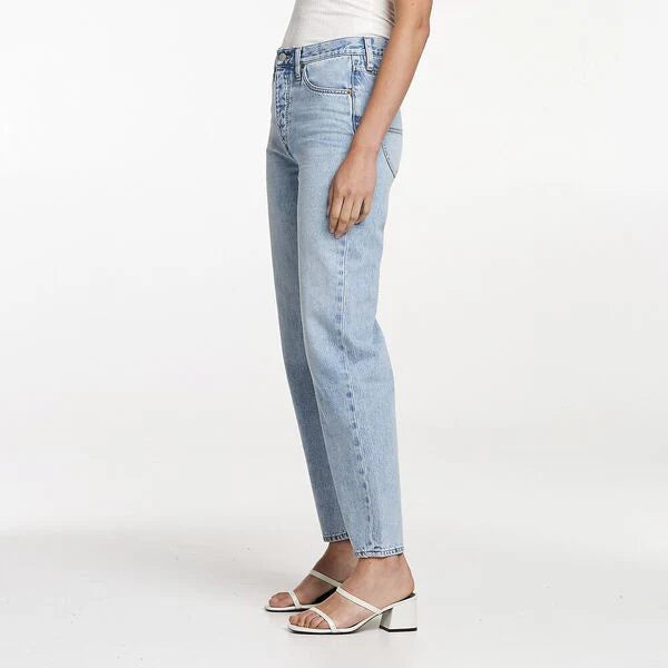 Light blue jeans worn by a person on a white background