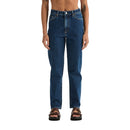 Person wearing blue jeans on a plain background